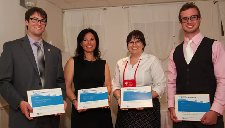 Picture of 2013 Wellspring Award recipients, two men and two women holding their plaques