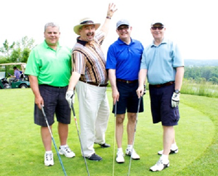 Image of four male golfers posing for a photo