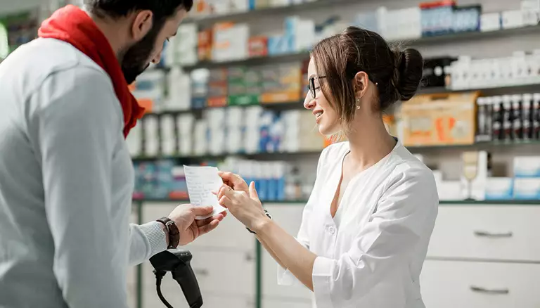 Canadian pharmacy in transition | Picture of female pharmacist explaining details of prescription to male patient - The Candian Foundation For Pharmacy