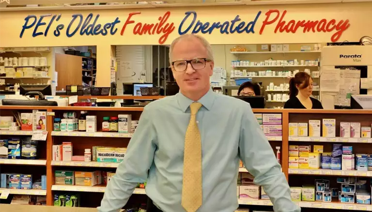 Embracing Change: Sherwood Drug Mart, PEI | Picture of man posing in front of shelves at a pharmacy - The Canadian Foundation For Pharmacy