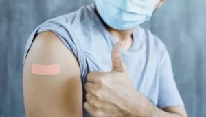 Pharmacy's value as vaccinators: new research | Picture of man with his t-shirt sleeve rolled up showing a band aid on his arm and giving a thumbs up - The Canadian Foundation For Pharmacy