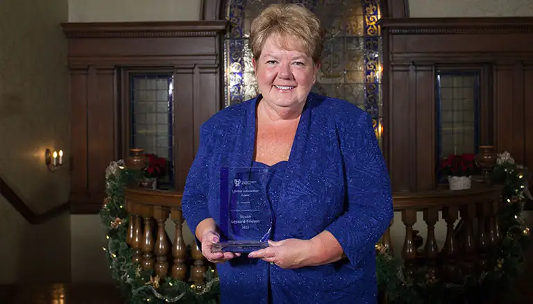 Picture of Susan Lessard-Friesen holding her Lifetime Achievement Award - Canadian Foundation For Pharmacy